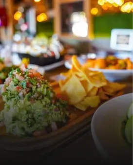 there are many plates of food on the table with chips