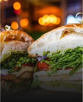 there are two sandwiches on a plate with a ring on top