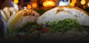 there are two sandwiches with lettuce and tomato on them