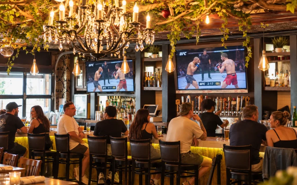 An interior bar with two large screen TVs displaying a UFC fight